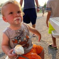 Little boy with ice cream cone and ice cream on his face