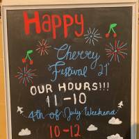 Sign with Happy Cherry Festival 21' out Hours 11-10. 4thof July Weekend 10-12