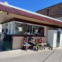 Family sitting on bench enjoying ice cream